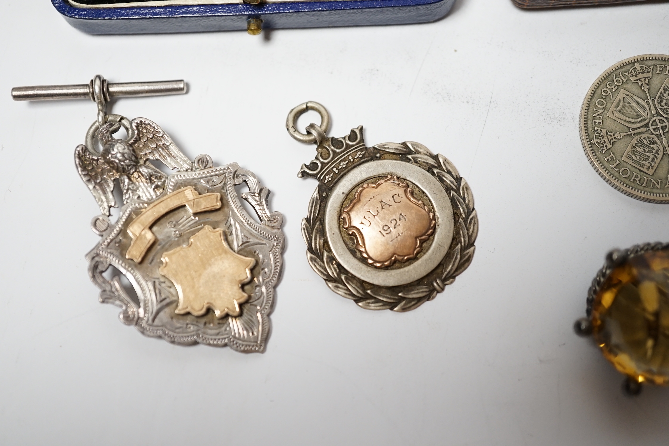 A pair of engine turned 9ct gold cufflinks, a yellow metal and enamel bar brooch, a white metal mounted citrine brooch, two silver medallions and two George V coins.
